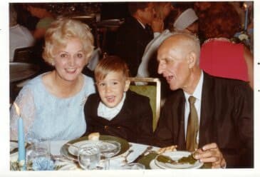 Helen Schabinger with her husband and young son at a dinner table in 1969